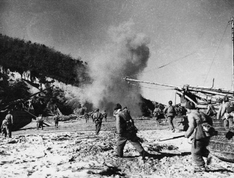 The People's Volunteer Army disembarks on a western Korean island under the cover of artillery and machine guns