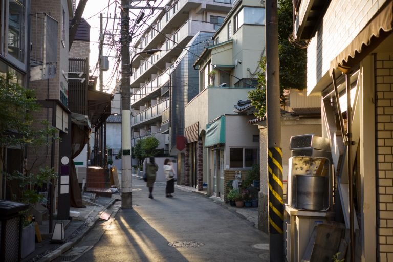 Traditional alleyways framed by skyscrapers in Tokyo