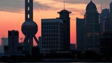 Modern Shanghai skyline layered over war history